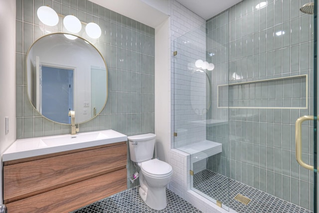 601 Foxborough Sq W, Brentwood, TN 37027 - full bathroom with tile walls, vanity, tiled shower, toilet, and tile patterned floors