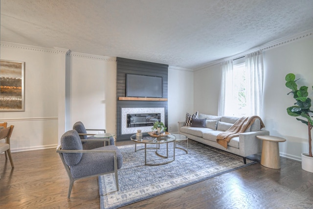 601 Foxborough Sq W, Brentwood, TN 37027 - living room featuring a textured ceiling, wood finished floors, a large fireplace, baseboards, and crown molding