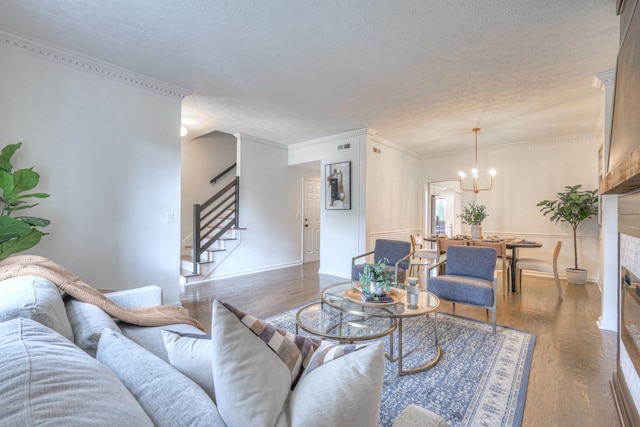 601 Foxborough Sq W, Brentwood, TN 37027 - living area featuring a textured ceiling, stairway, wood finished floors, a chandelier, and a glass covered fireplace