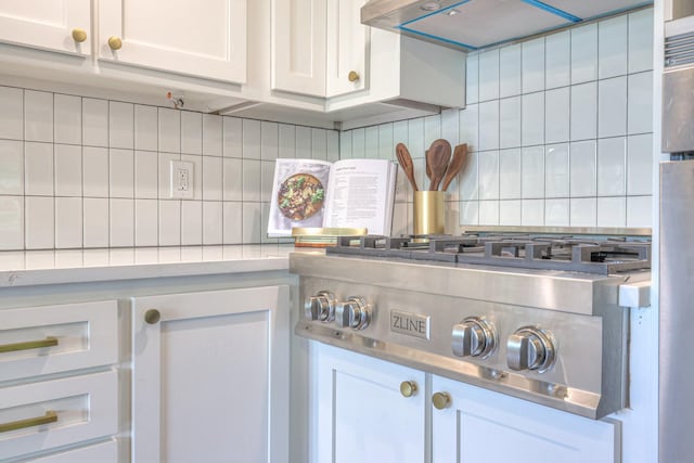 601 Foxborough Sq W, Brentwood, TN 37027 - kitchen view of decorative backsplash, light countertops, white cabinets, extractor fan, and stainless steel gas stovetop