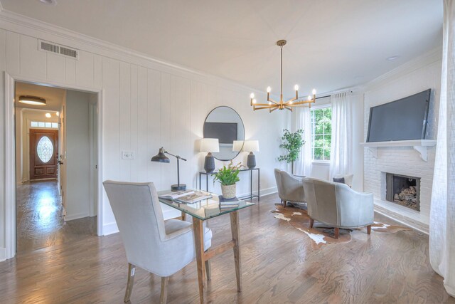 601 Foxborough Sq W, Brentwood, TN 37027 - dining area with crown molding, a chandelier, wood finished floors, a fireplace, and baseboards