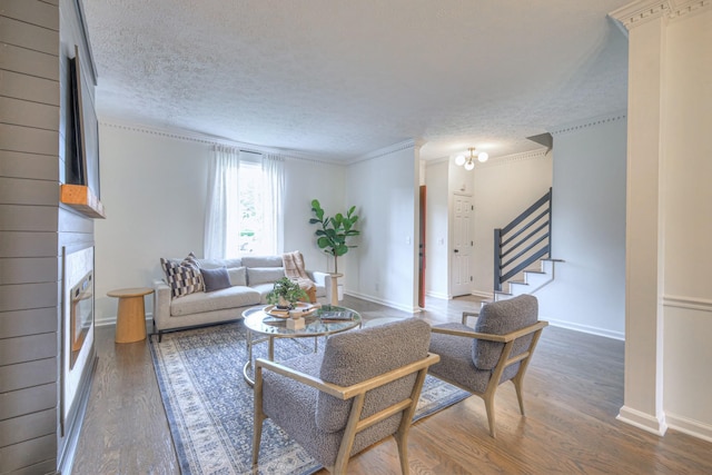 601 Foxborough Sq W, Brentwood, TN 37027 - living area with a fireplace, wood finished floors, stairway, baseboards, and a textured ceiling