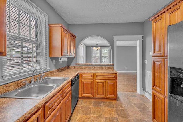 2408 Elliott Dr, Old Hickory, TN 37138 - kitchen with a notable chandelier, appliances with stainless steel finishes, a sink, a textured ceiling, and brown cabinetry