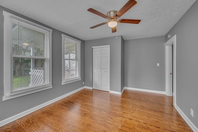 2408 Elliott Dr, Old Hickory, TN 37138 - unfurnished bedroom with baseboards, a textured ceiling, wood finished floors, and a closet