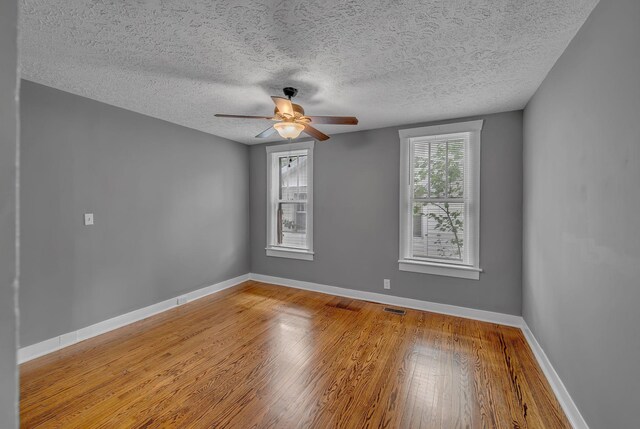 2408 Elliott Dr, Old Hickory, TN 37138 - unfurnished room featuring visible vents, wood finished floors, baseboards, ceiling fan, and a textured ceiling