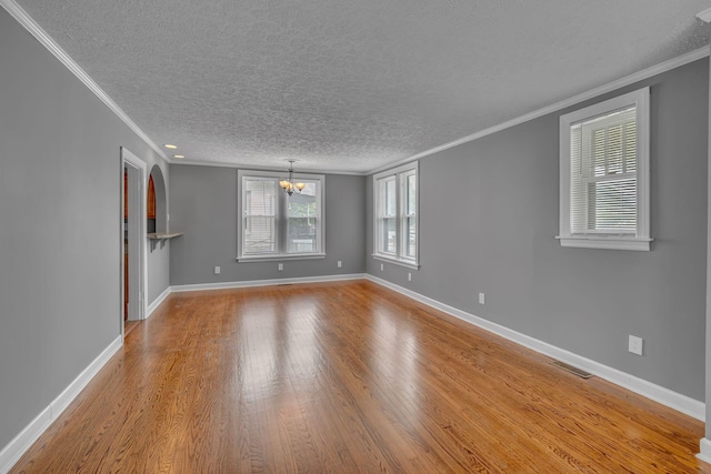 2408 Elliott Dr, Old Hickory, TN 37138 - unfurnished living room with visible vents, crown molding, wood finished floors, and a notable chandelier