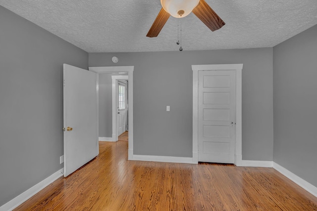 2408 Elliott Dr, Old Hickory, TN 37138 - unfurnished bedroom with baseboards, a textured ceiling, and wood finished floors