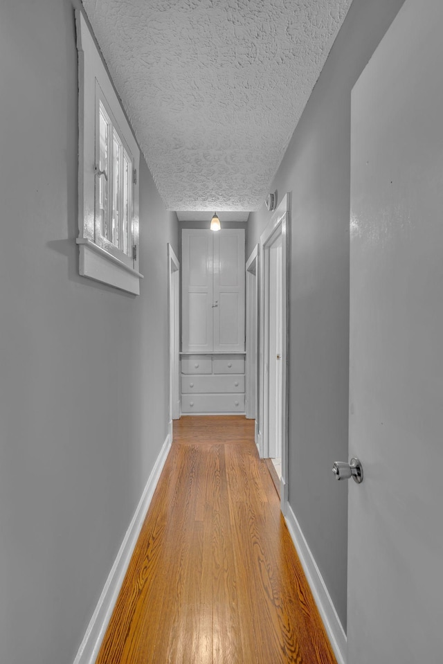 2408 Elliott Dr, Old Hickory, TN 37138 - hallway featuring light wood-style floors, baseboards, and a textured ceiling
