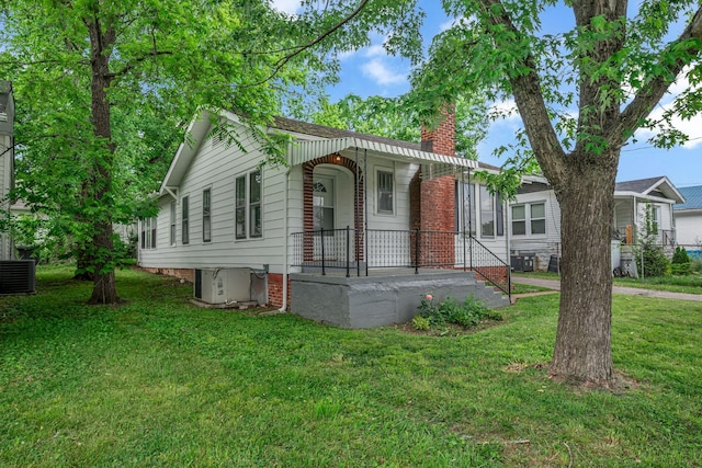2408 Elliott Dr, Old Hickory, TN 37138 - view of front facade with central AC unit, a chimney, covered porch, and a front yard