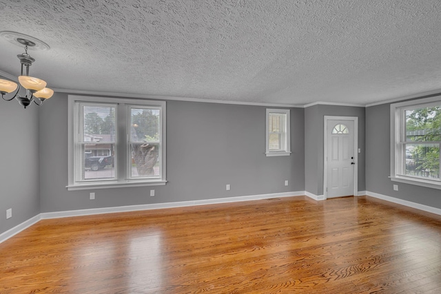 2408 Elliott Dr, Old Hickory, TN 37138 - interior space featuring a textured ceiling, a chandelier, ornamental molding, and light wood-type flooring