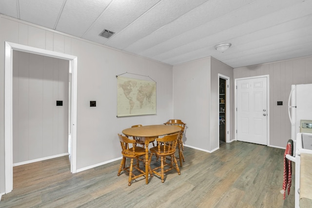 dining room with baseboards, visible vents, and wood finished floors