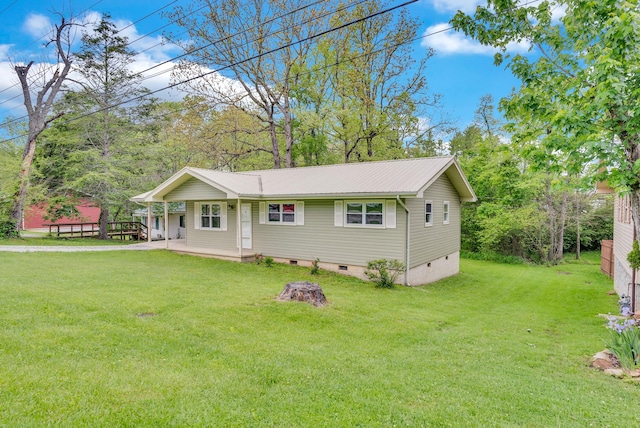 view of front of home with crawl space, metal roof, and a front lawn