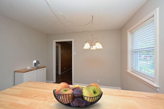 102 Moore Ave, Portland, TN 37148 - dining area with baseboards, an inviting chandelier, and wood finished floors