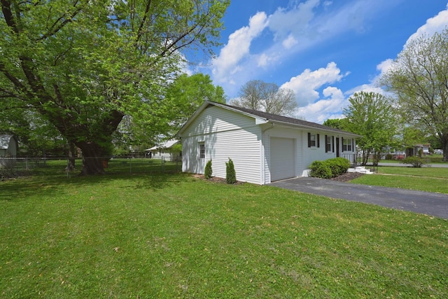102 Moore Ave, Portland, TN 37148 - view of property exterior featuring a lawn, an attached garage, fence, and driveway