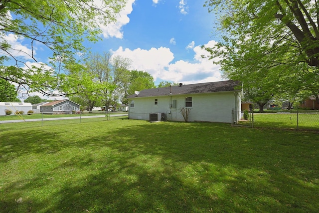 102 Moore Ave, Portland, TN 37148 - back of property with a lawn, fence, and cooling unit