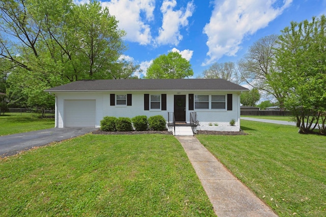 102 Moore Ave, Portland, TN 37148 - view of front of home with a garage, fence, a front lawn, and aphalt driveway
