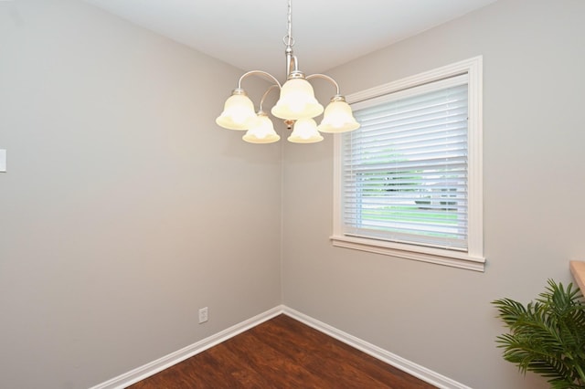 102 Moore Ave, Portland, TN 37148 - spare room featuring baseboards, dark wood-style flooring, and a chandelier