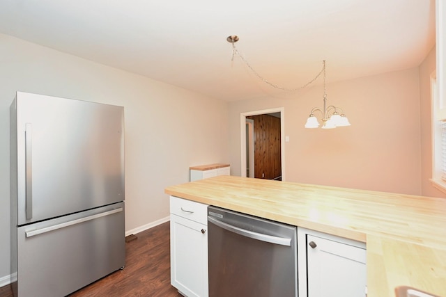 102 Moore Ave, Portland, TN 37148 - kitchen featuring appliances with stainless steel finishes, white cabinets, a chandelier, wood counters, and dark wood-type flooring