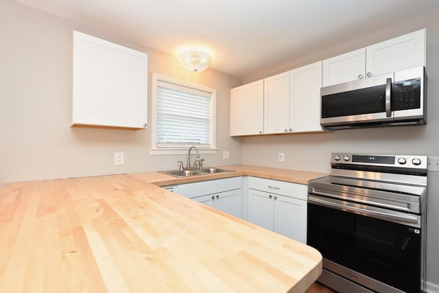 102 Moore Ave, Portland, TN 37148 - kitchen with a sink, wood counters, white cabinets, and stainless steel appliances