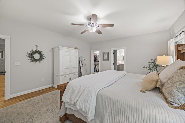 6437 Arno Rd, College Grove, TN 37046 - bedroom featuring light wood-style floors, baseboards, a spacious closet, a closet, and ceiling fan