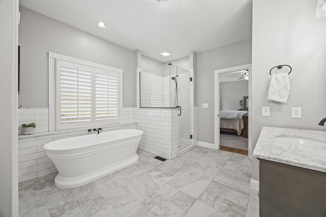 6437 Arno Rd, College Grove, TN 37046 - ensuite bathroom featuring a freestanding tub, a shower stall, vanity, a ceiling fan, and tile walls