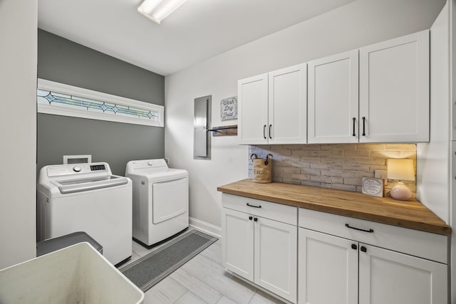 6437 Arno Rd, College Grove, TN 37046 - clothes washing area featuring separate washer and dryer, cabinet space, electric panel, and baseboards