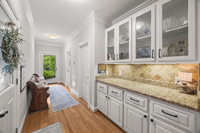 6437 Arno Rd, College Grove, TN 37046 - bar area featuring tasteful backsplash, light wood-style floors, baseboards, and crown molding
