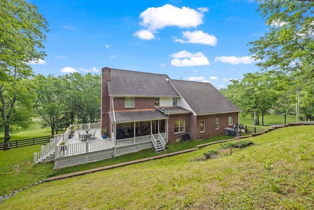 6437 Arno Rd, College Grove, TN 37046 - back of property featuring a sunroom, brick siding, a wooden deck, roof with shingles, and central AC unit