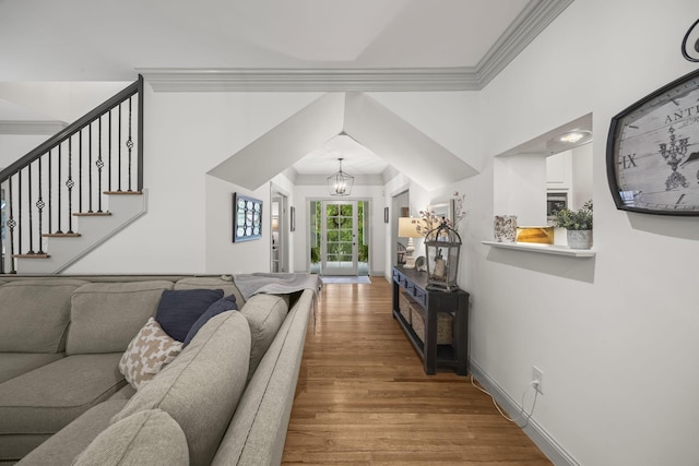 6437 Arno Rd, College Grove, TN 37046 - living area featuring light wood finished floors, crown molding, stairway, and a chandelier