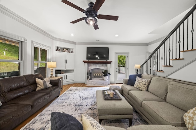 6437 Arno Rd, College Grove, TN 37046 - living area with light wood finished floors, stairway, ornamental molding, ceiling fan, and a fireplace with raised hearth