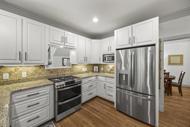 6437 Arno Rd, College Grove, TN 37046 - kitchen featuring appliances with stainless steel finishes, dark wood-style flooring, white cabinetry, decorative backsplash, and recessed lighting
