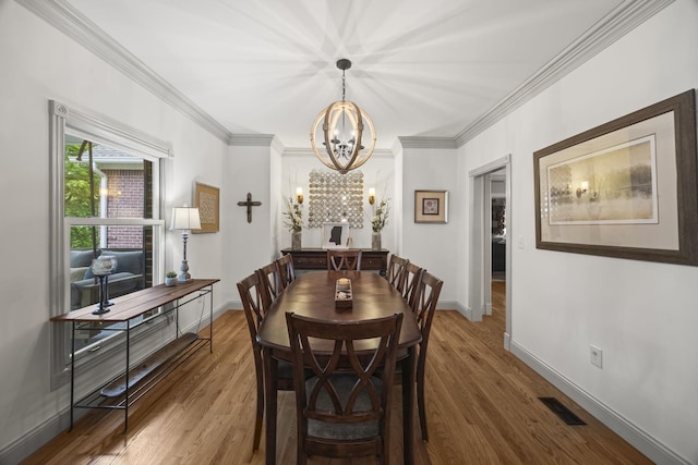 6437 Arno Rd, College Grove, TN 37046 - dining space featuring a chandelier, wood finished floors, crown molding, and baseboards