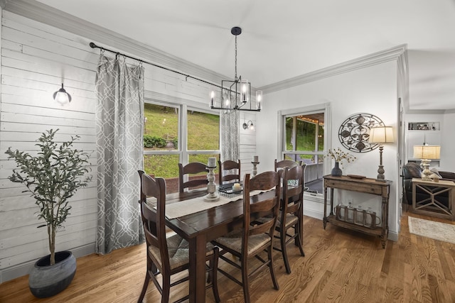 6437 Arno Rd, College Grove, TN 37046 - dining space featuring wood finished floors, a chandelier, crown molding, and wooden walls