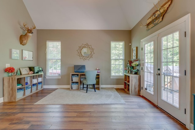 office area with baseboards, hardwood / wood-style flooring, french doors, and lofted ceiling