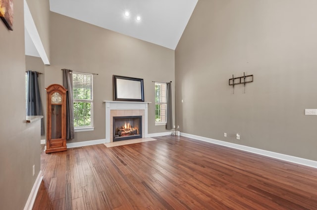 990 Iron Hill Rd, Burns, TN 37029 - unfurnished living room with high vaulted ceiling, wood finished floors, a fireplace, and baseboards