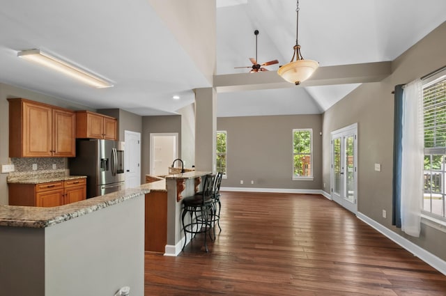 990 Iron Hill Rd, Burns, TN 37029 - kitchen featuring stainless steel fridge with ice dispenser, dark wood-style floors, light stone countertops, baseboards, and open floor plan