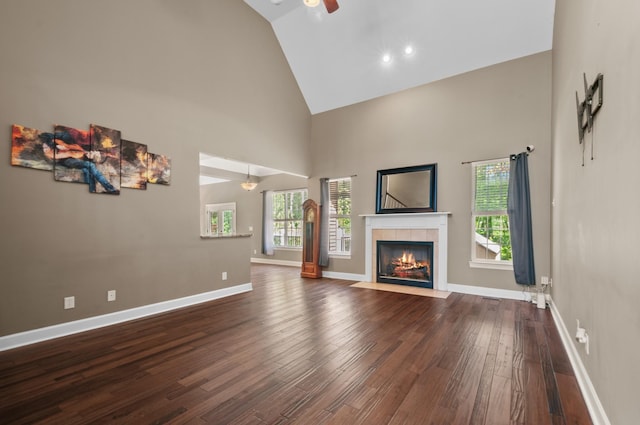 990 Iron Hill Rd, Burns, TN 37029 - unfurnished living room featuring ceiling fan, high vaulted ceiling, dark wood finished floors, a tile fireplace, and baseboards