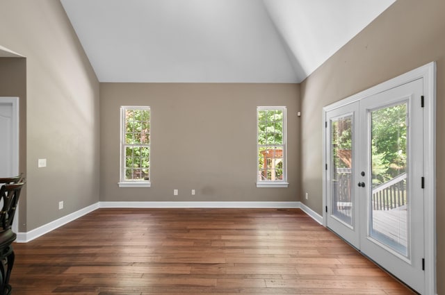 990 Iron Hill Rd, Burns, TN 37029 - unfurnished living room featuring high vaulted ceiling, hardwood / wood-style flooring, and baseboards