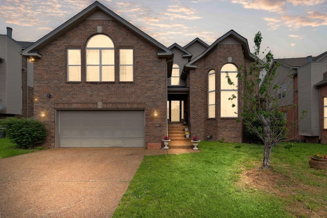 5512 Oak Chase Dr, Antioch, TN 37013 - view of front of property featuring concrete driveway, a front lawn, brick siding, entry steps, and an attached garage