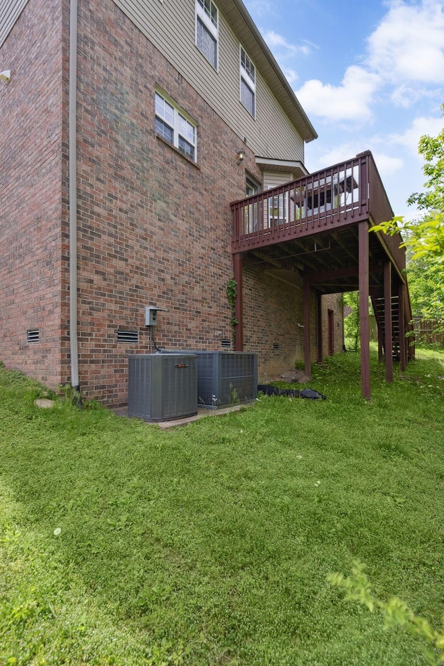 5512 Oak Chase Dr, Antioch, TN 37013 - rear view of property with central air condition unit, a yard, and a deck