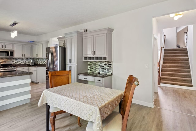 5512 Oak Chase Dr, Antioch, TN 37013 - dining room with baseboards, light wood finished floors, and stairs