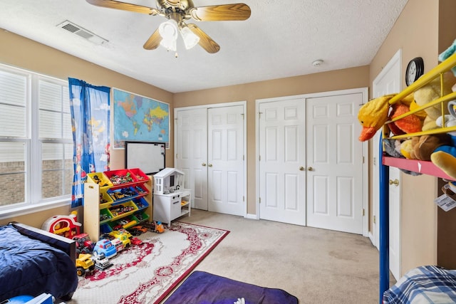 5512 Oak Chase Dr, Antioch, TN 37013 - carpeted bedroom featuring multiple windows, a ceiling fan, two closets, and visible vents