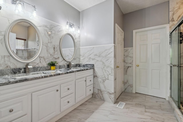 5512 Oak Chase Dr, Antioch, TN 37013 - full bath with double vanity, tile walls, a shower stall, a sink, and marble finish floor