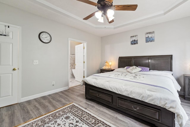 5512 Oak Chase Dr, Antioch, TN 37013 - bedroom featuring ceiling fan, a raised ceiling, baseboards, ensuite bath, and light wood-style flooring