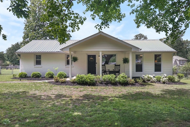 316 S Hummingbird Ln, Dickson, TN 37055 - view of front facade with metal roof, covered porch, and brick siding