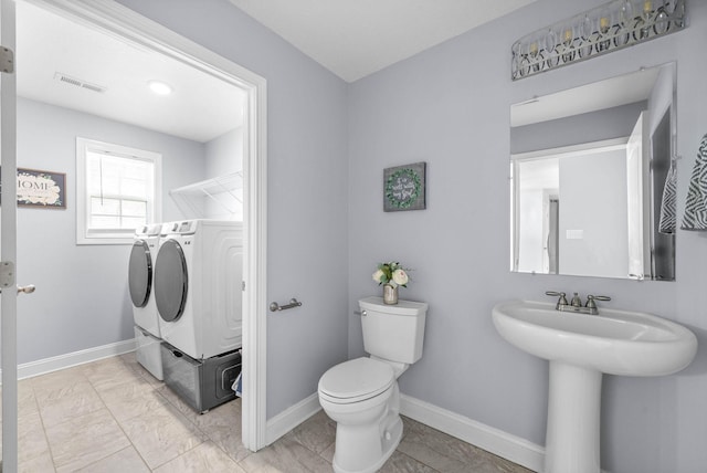 1145 Racker Dr, Clarksville, TN 37043 - full bath with visible vents, baseboards, toilet, and washing machine and clothes dryer