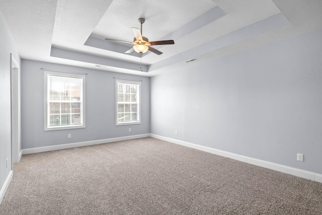 1145 Racker Dr, Clarksville, TN 37043 - carpeted spare room featuring visible vents, a raised ceiling, ceiling fan, and baseboards