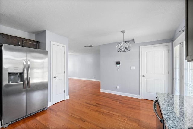 1145 Racker Dr, Clarksville, TN 37043 - kitchen with a notable chandelier, baseboards, appliances with stainless steel finishes, and visible vents