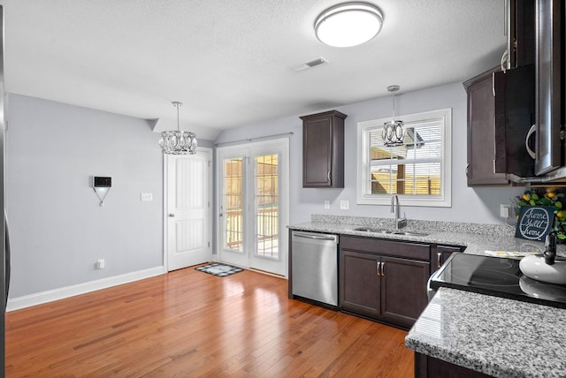 1145 Racker Dr, Clarksville, TN 37043 - kitchen featuring dark brown cabinets, a notable chandelier, a sink, stainless steel dishwasher, and visible vents