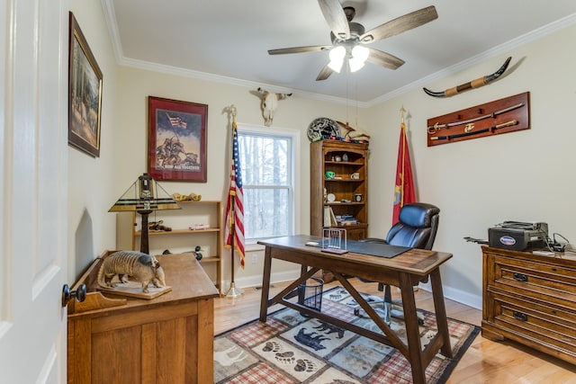office with crown molding, baseboards, a ceiling fan, and light wood-style flooring